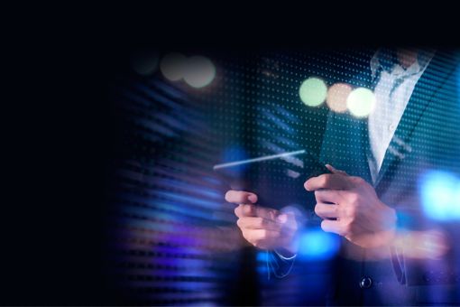 businessman typing financial data on tablet