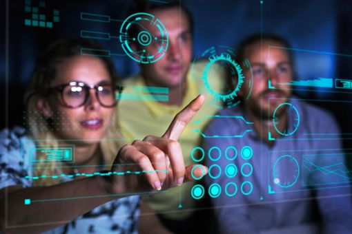 programmers examining data on futuristic hologram