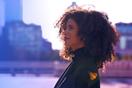 women look into the distance with a smile